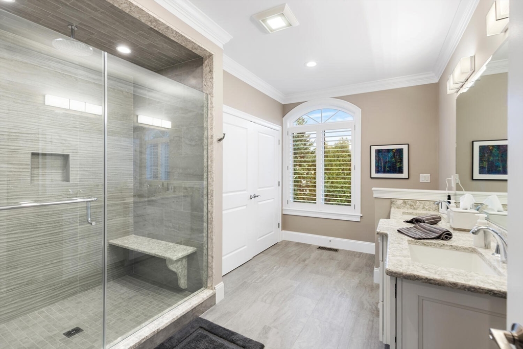 37 Crenshaw Lane, Unit 37 Andover, MA 01810 - Photo 21 of 40 a bathroom with a granite countertop sink a large mirror and shower