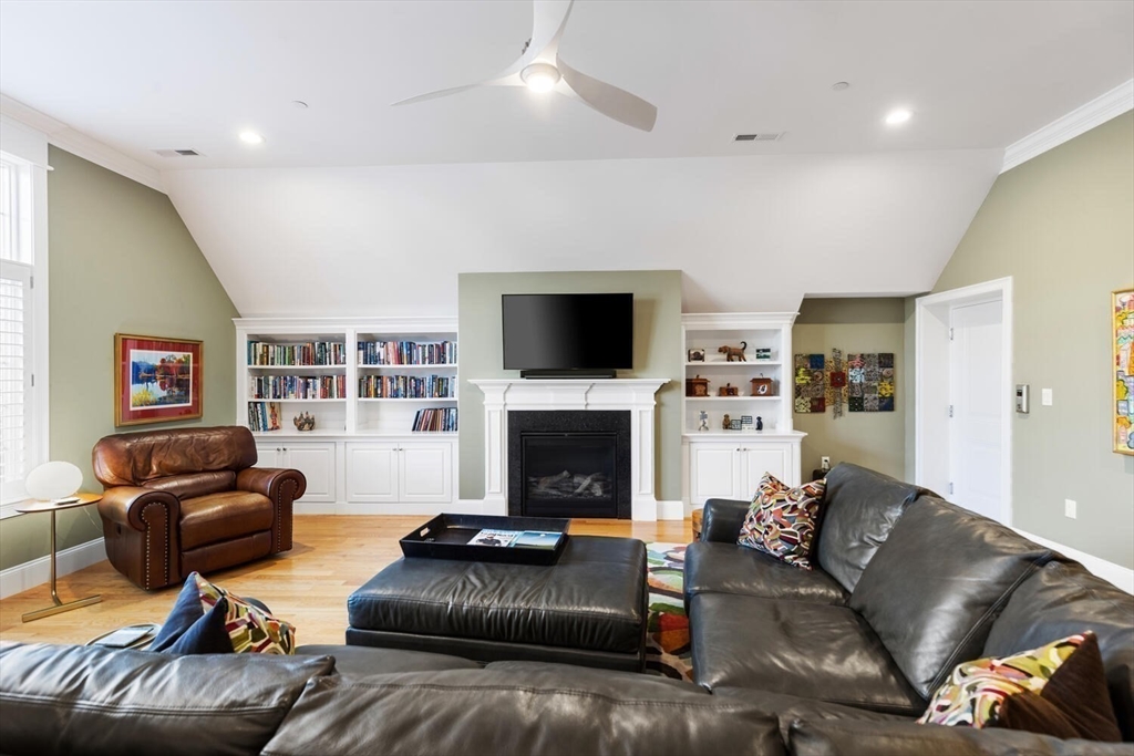 37 Crenshaw Lane, Unit 37 Andover, MA 01810 - Photo 24 of 40 a living room with furniture a fireplace and a flat screen tv