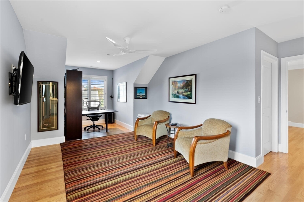 37 Crenshaw Lane, Unit 37 Andover, MA 01810 - Photo 26 of 40 a living room with furniture a flat screen tv and rug