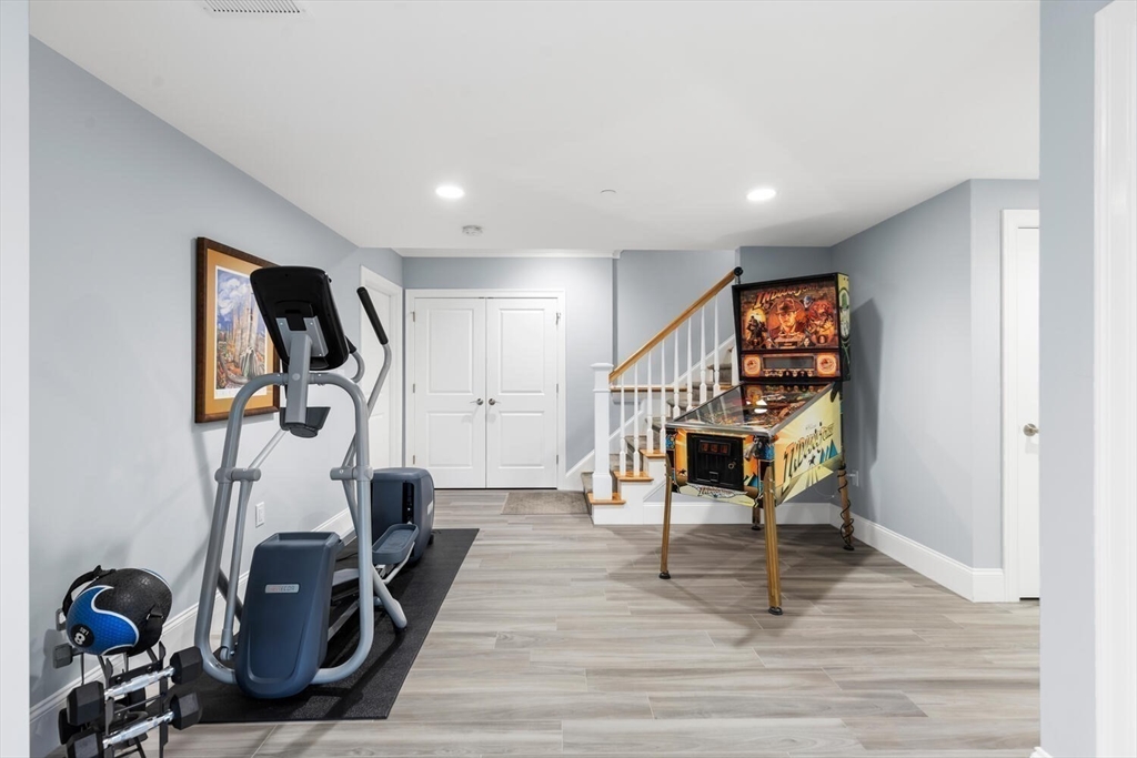 37 Crenshaw Lane, Unit 37 Andover, MA 01810 - Photo 31 of 40 a living room with furniture and a wooden floor