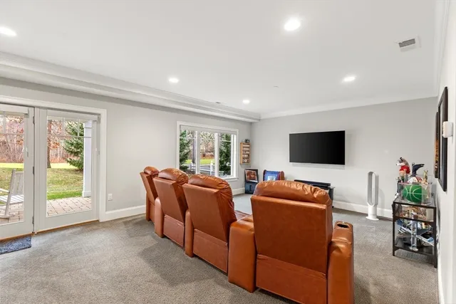 a living room with furniture pool table and a large window