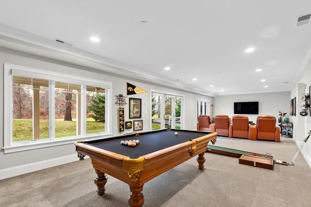 a bathroom with a double vanity sink a toilet and shower