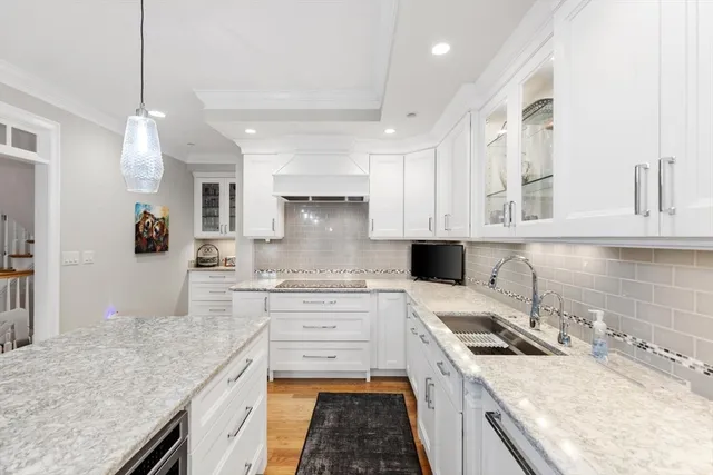 a kitchen with a sink stove top oven and cabinets