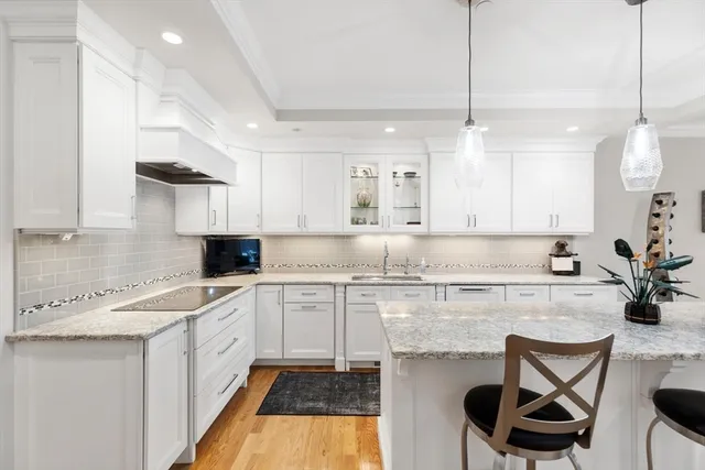 a kitchen with a sink a stove and cabinets