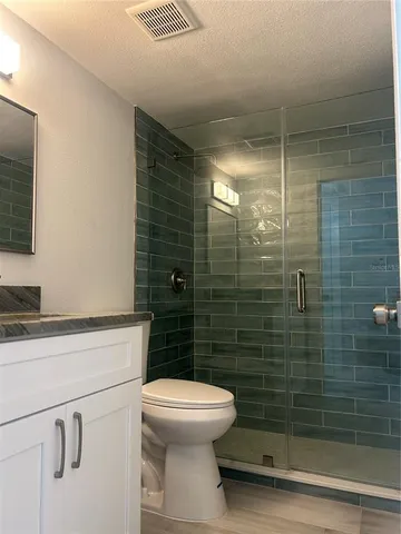 a bathroom with a toilet a sink and shower