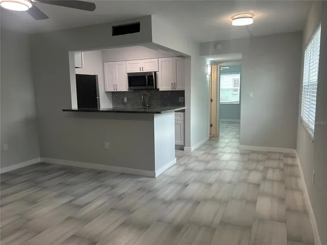 a kitchen with stainless steel appliances granite countertop a stove and a microwave