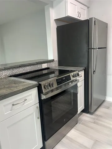 a stove top oven sitting inside of a kitchen