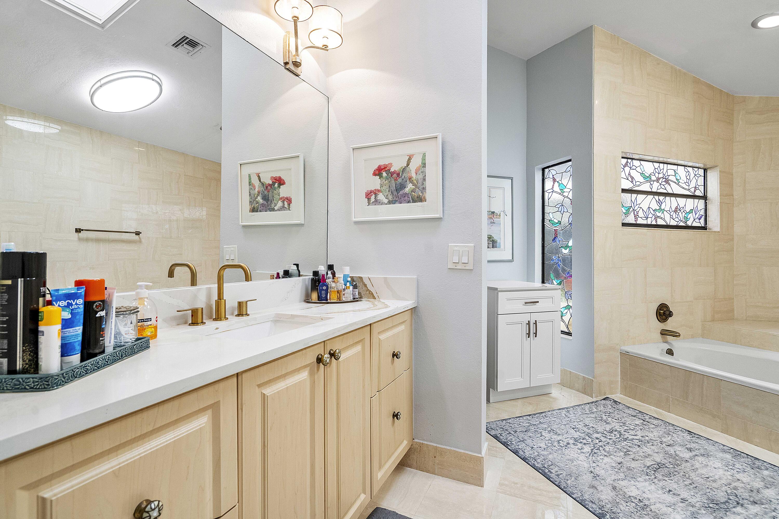 22652 Esplanada Circle Boca Raton, FL 33433 - Photo 11 of 44 a bathroom with a tub sink and a mirror