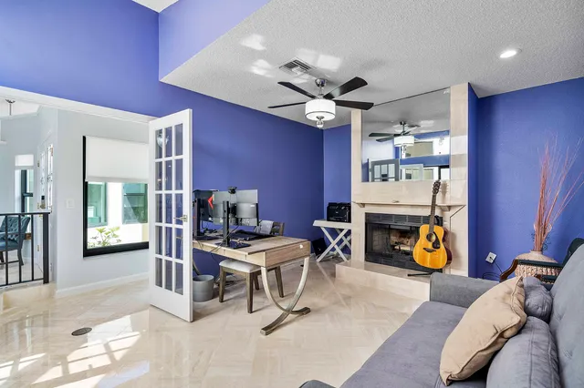 a view of a livingroom with workspace and a window