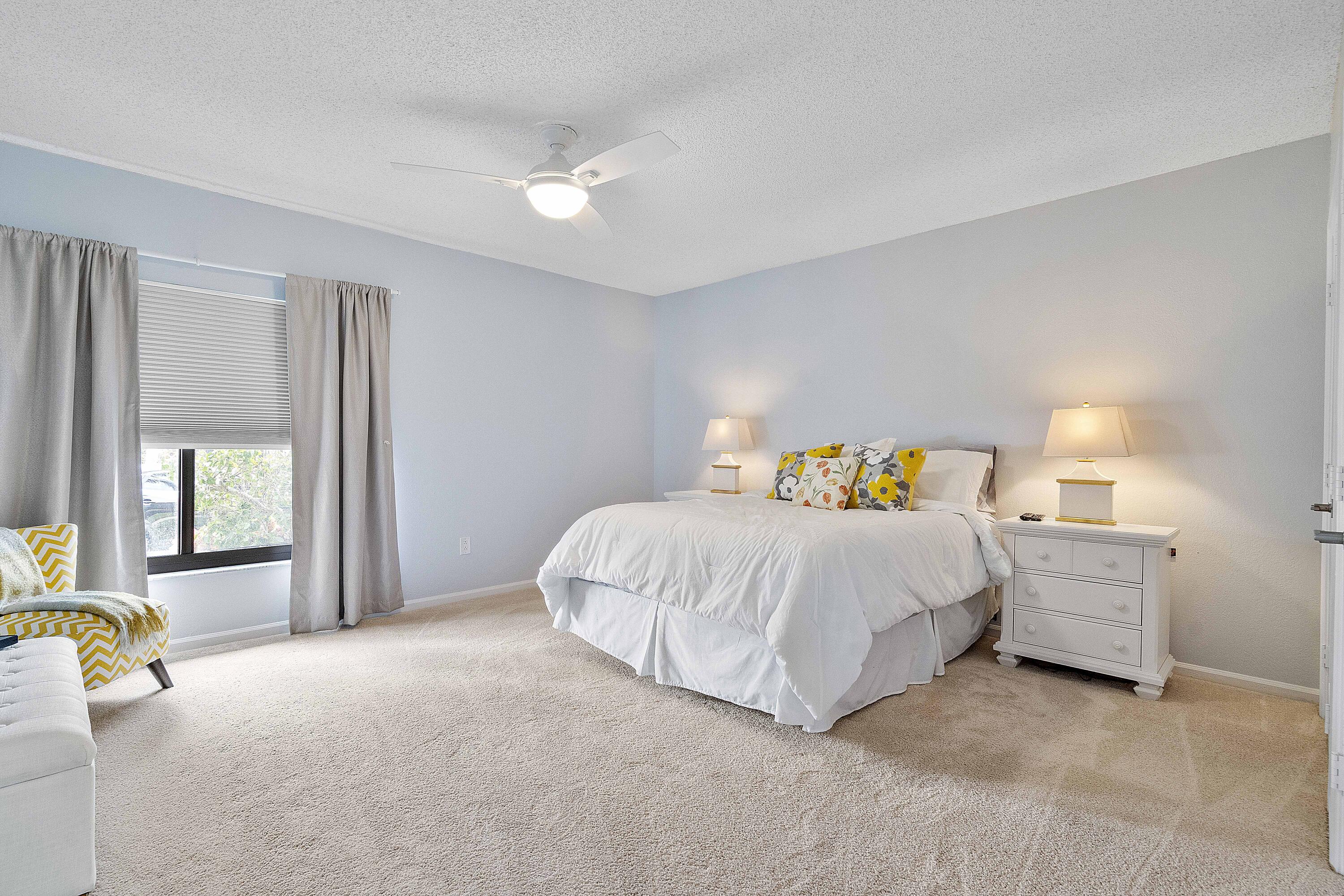 22652 Esplanada Circle Boca Raton, FL 33433 - Photo 14 of 44 a spacious bedroom with a bed and a lamp