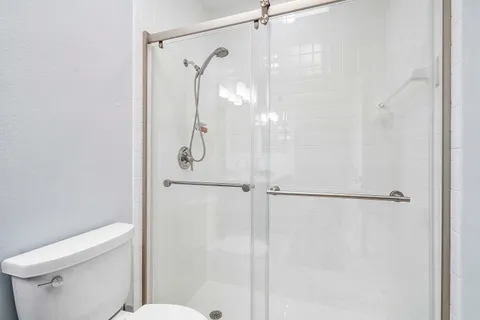 a bathroom with a glass shower door