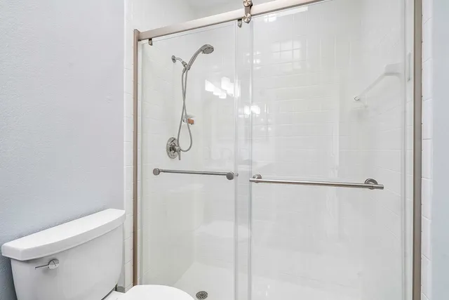 a bathroom with a glass shower door