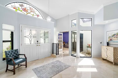 a living room with furniture and a large mirror