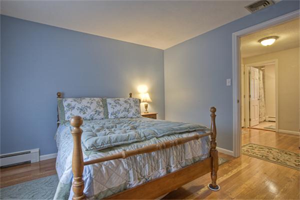 6 Random Lane Andover, MA 01810 - Photo 16 of 30 a bedroom with a bed and wooden floor