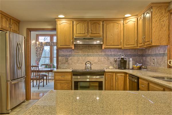 6 Random Lane Andover, MA 01810 - Photo 6 of 30 a kitchen with stainless steel appliances granite countertop a refrigerator a sink dishwasher a stove with wooden cabinets and floor