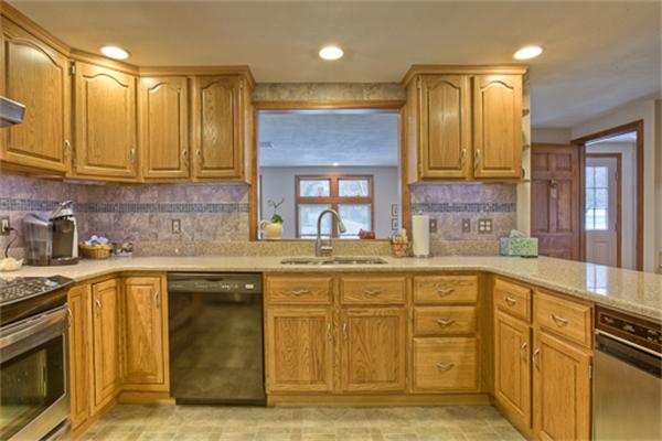 6 Random Lane Andover, MA 01810 - Photo 7 of 30 a kitchen with stainless steel appliances granite countertop a sink and cabinets