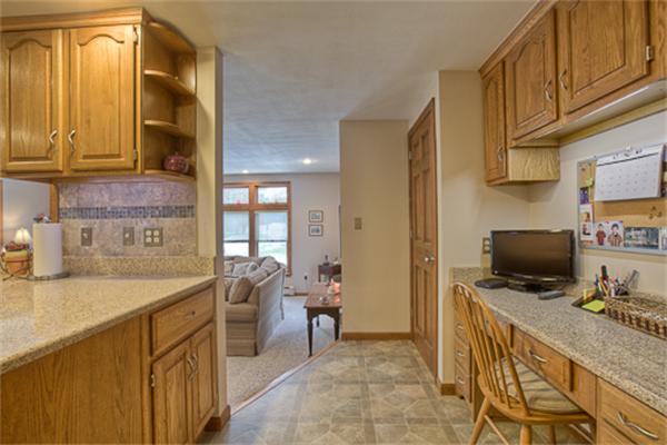 6 Random Lane Andover, MA 01810 - Photo 9 of 30 a view of a kitchen with a sink dishwasher refrigerator stove and a kitchen island