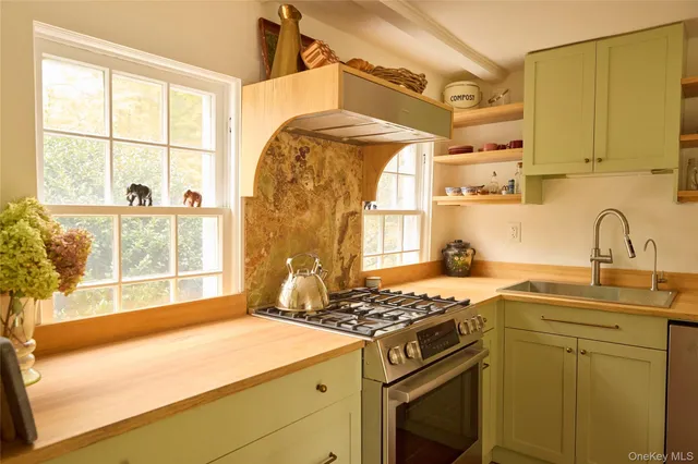 a kitchen with a sink stove and cabinets