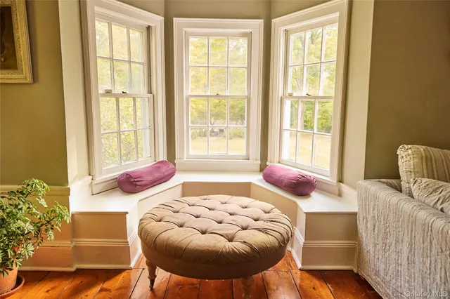 a bedroom with furniture and a large window