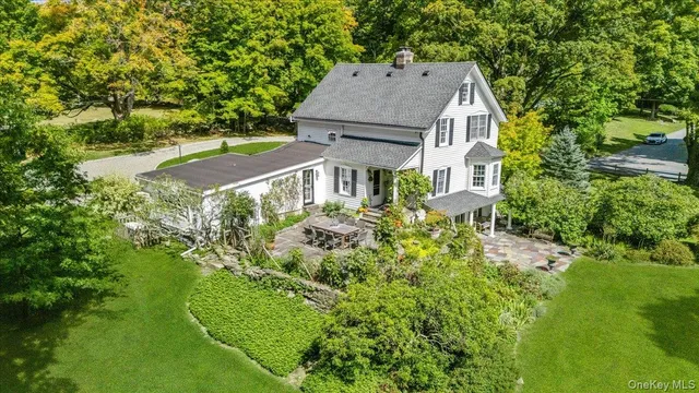 an aerial view of a house with a yard basket ball court and outdoor seating