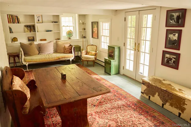 a living room with furniture and a floor to ceiling window