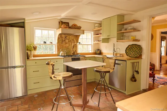 a view of a kitchen with a table and chairs