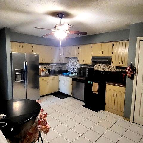 212 Madison Street, Unit 3B Joliet, IL 60435 - Photo 2 of 11 a kitchen with stainless steel appliances kitchen island granite countertop a stove a sink and a refrigerator