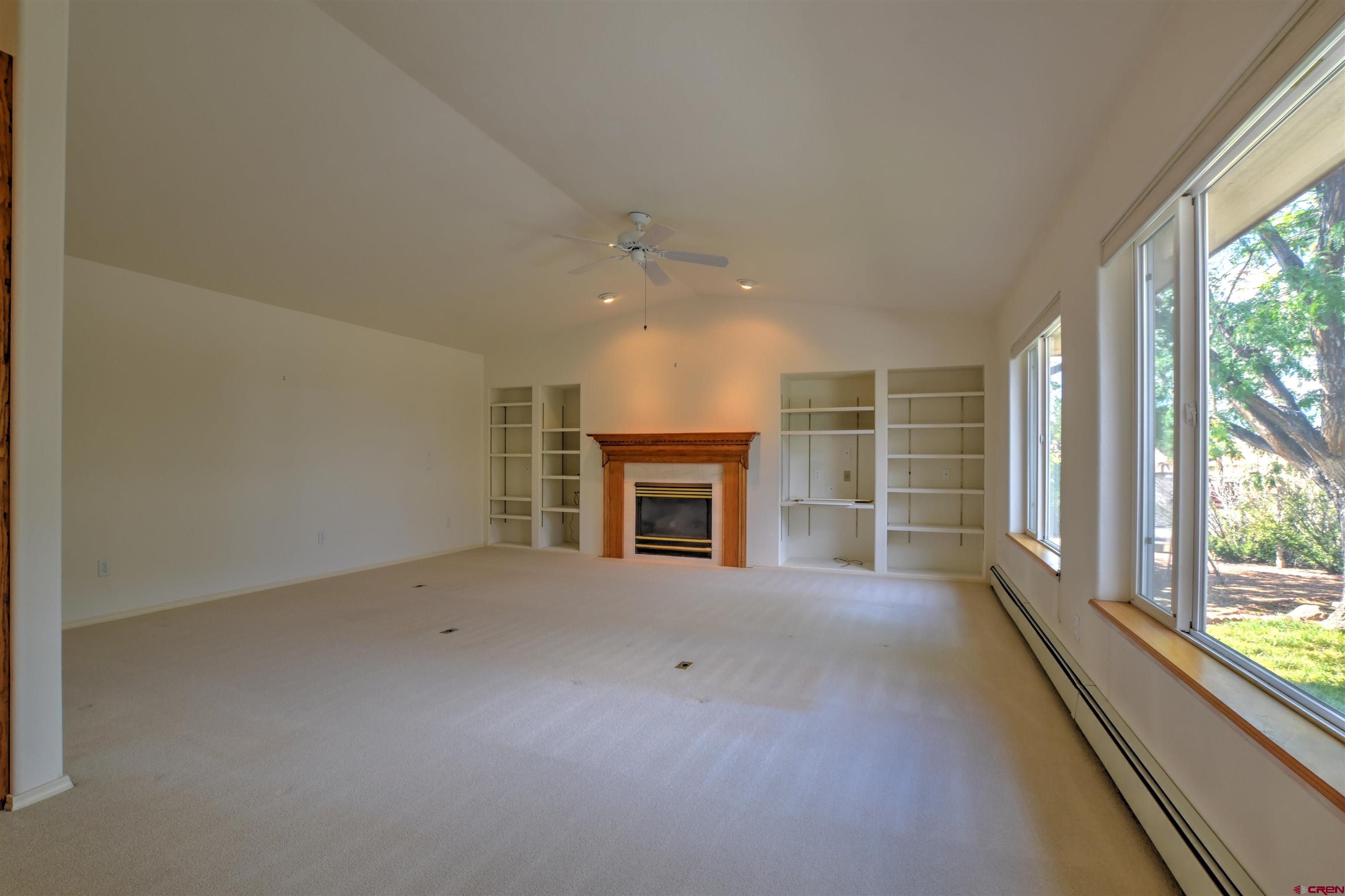 20607 Del Ray Drive Eckert, CO 81418 - Photo 14 of 27 an empty room with windows and fireplace
