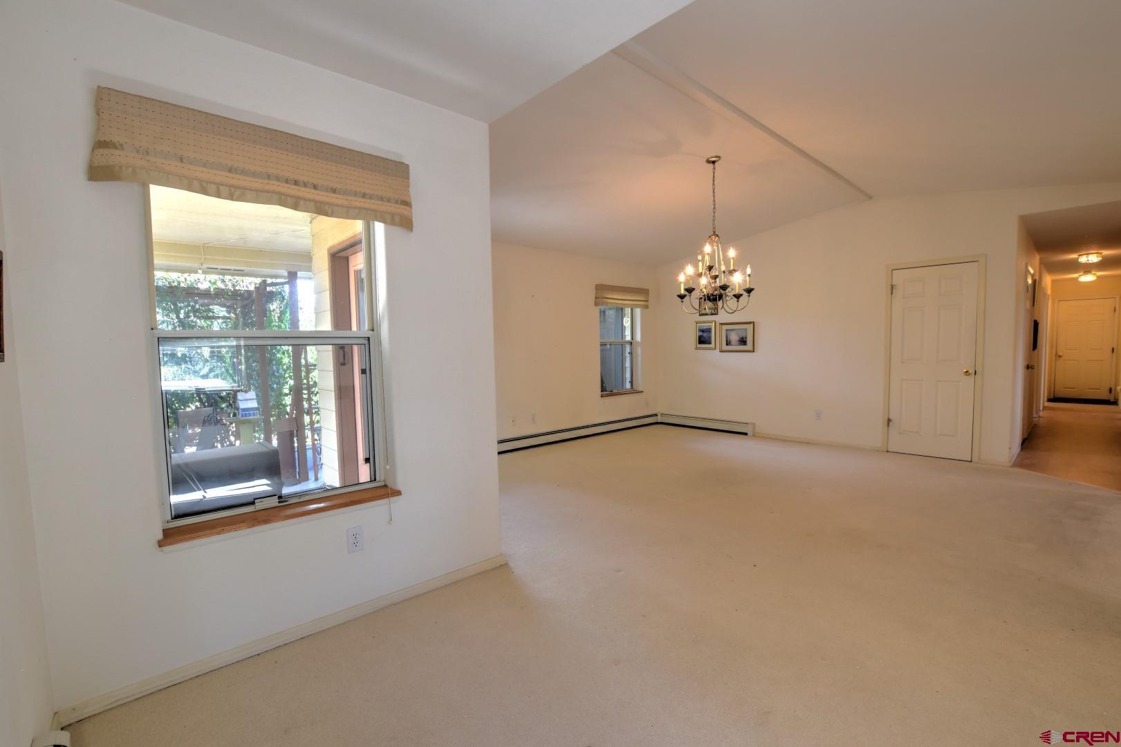 20607 Del Ray Drive Eckert, CO 81418 - Photo 16 of 27 a view of a livingroom with a chandelier fan and windows