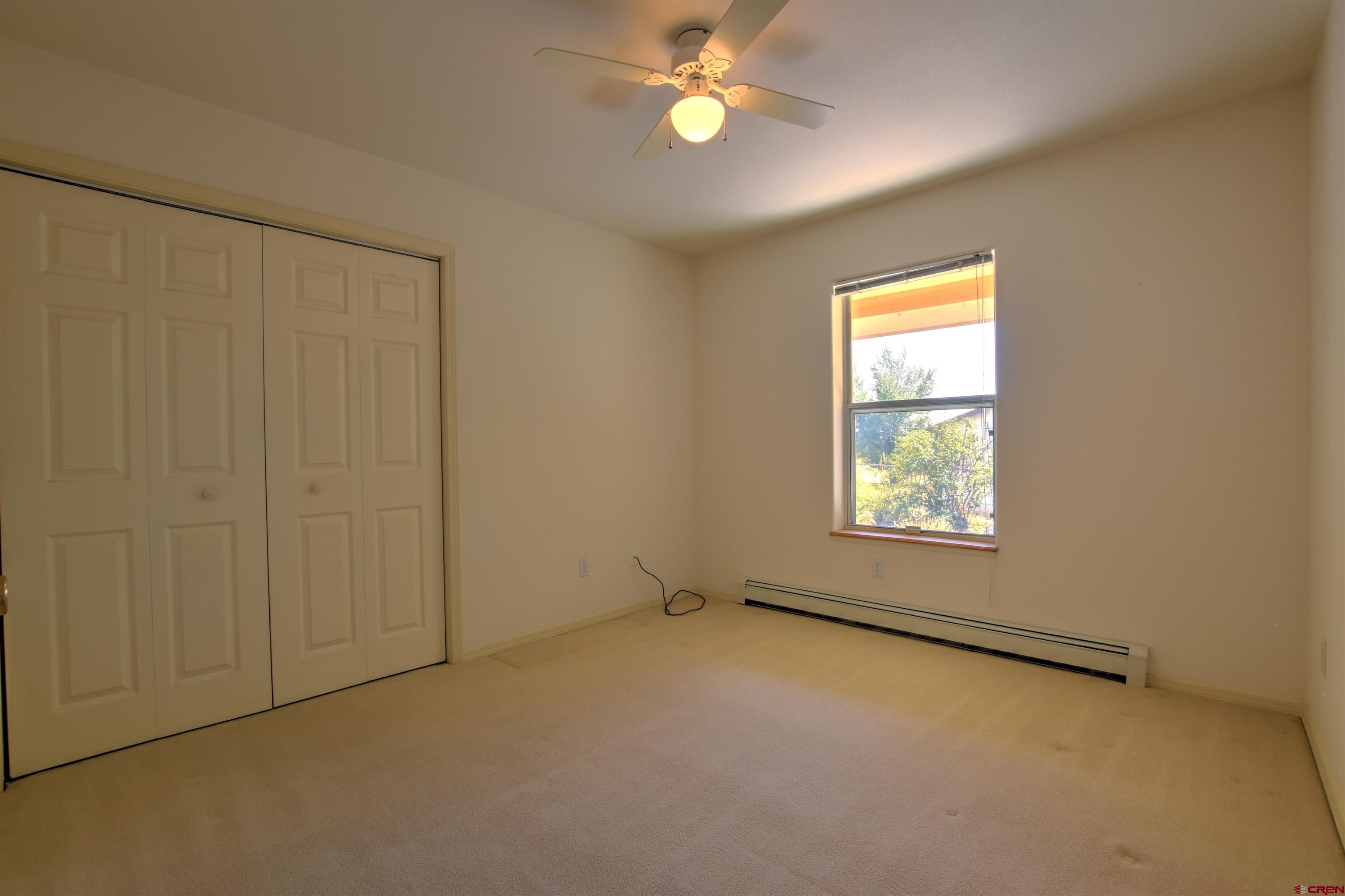 20607 Del Ray Drive Eckert, CO 81418 - Photo 17 of 27 an empty room with windows and fan