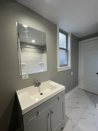 a bathroom with a sink vanity and mirror