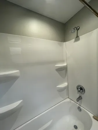 a bathroom with a bathtub and a toilet