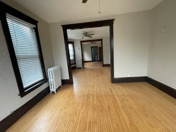 a view of a room with wooden floor and stairs