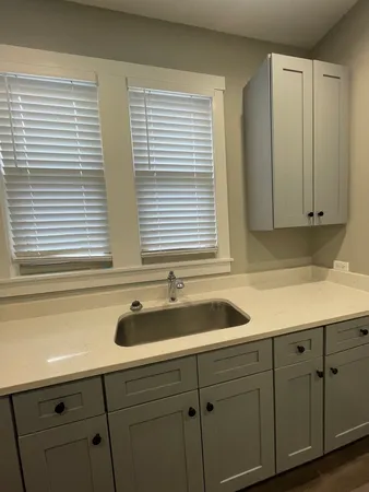 a kitchen with a sink and cabinets