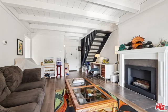 a view of a house with potted plants and a bench