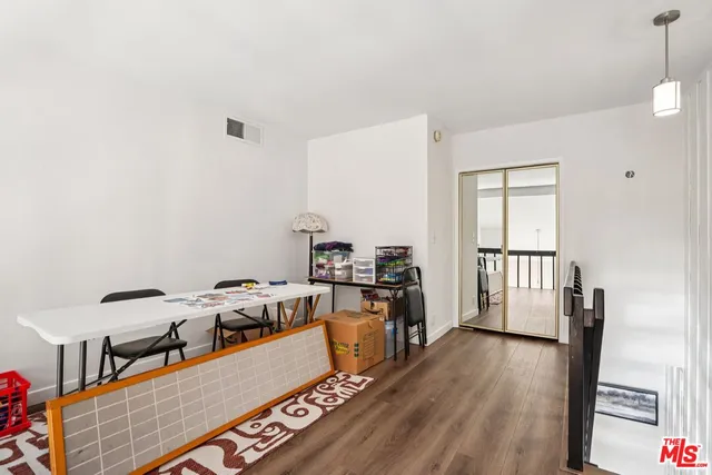 a large body of water next to a building with large trees