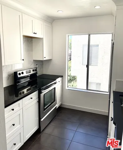 a bathroom with a bathtub sink vanity mirror and toilet