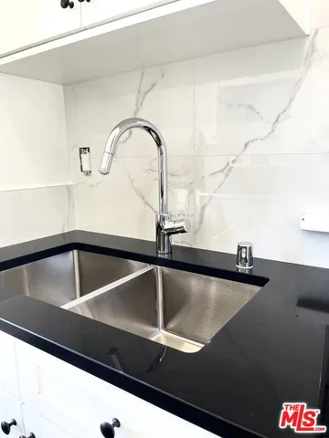 a bathroom with a shower and a sink