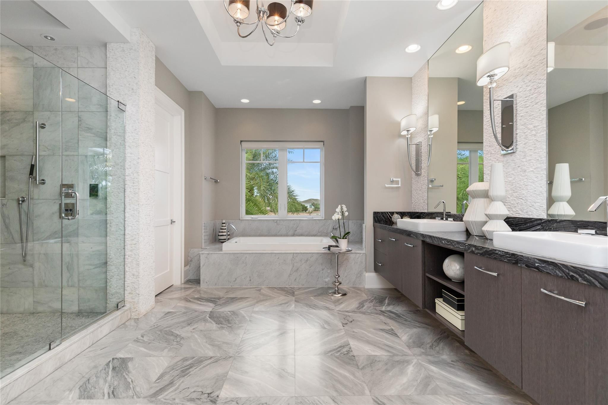 3211 Northeast 27th Avenue Lighthouse Point, FL 33064 - Photo 36 of 71 a large bathroom with a large tub sink shower and mirror