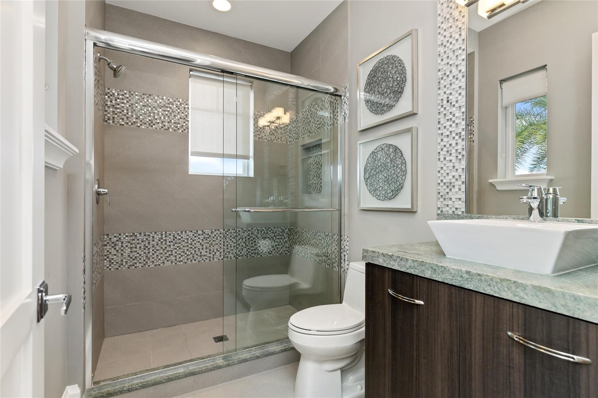 3211 Northeast 27th Avenue Lighthouse Point, FL 33064 - Photo 45 of 71 a bathroom with a granite countertop toilet sink and shower