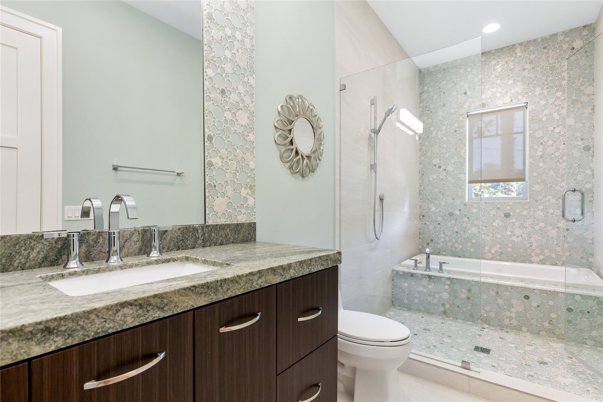 3211 Northeast 27th Avenue Lighthouse Point, FL 33064 - Photo 47 of 71 a bathroom with a granite countertop sink toilet and shower