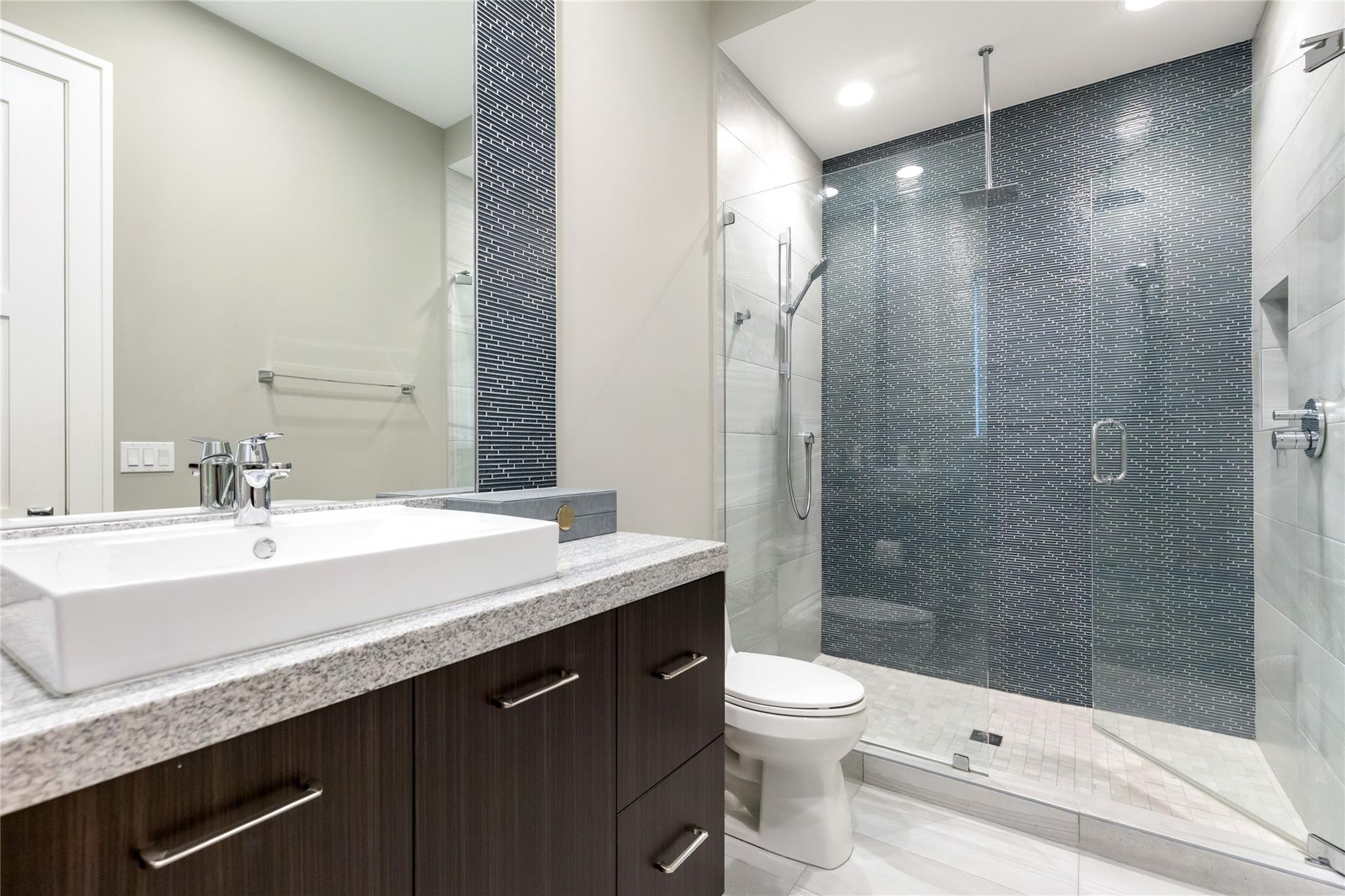 3211 Northeast 27th Avenue Lighthouse Point, FL 33064 - Photo 49 of 71 a bathroom with a sink a toilet and shower