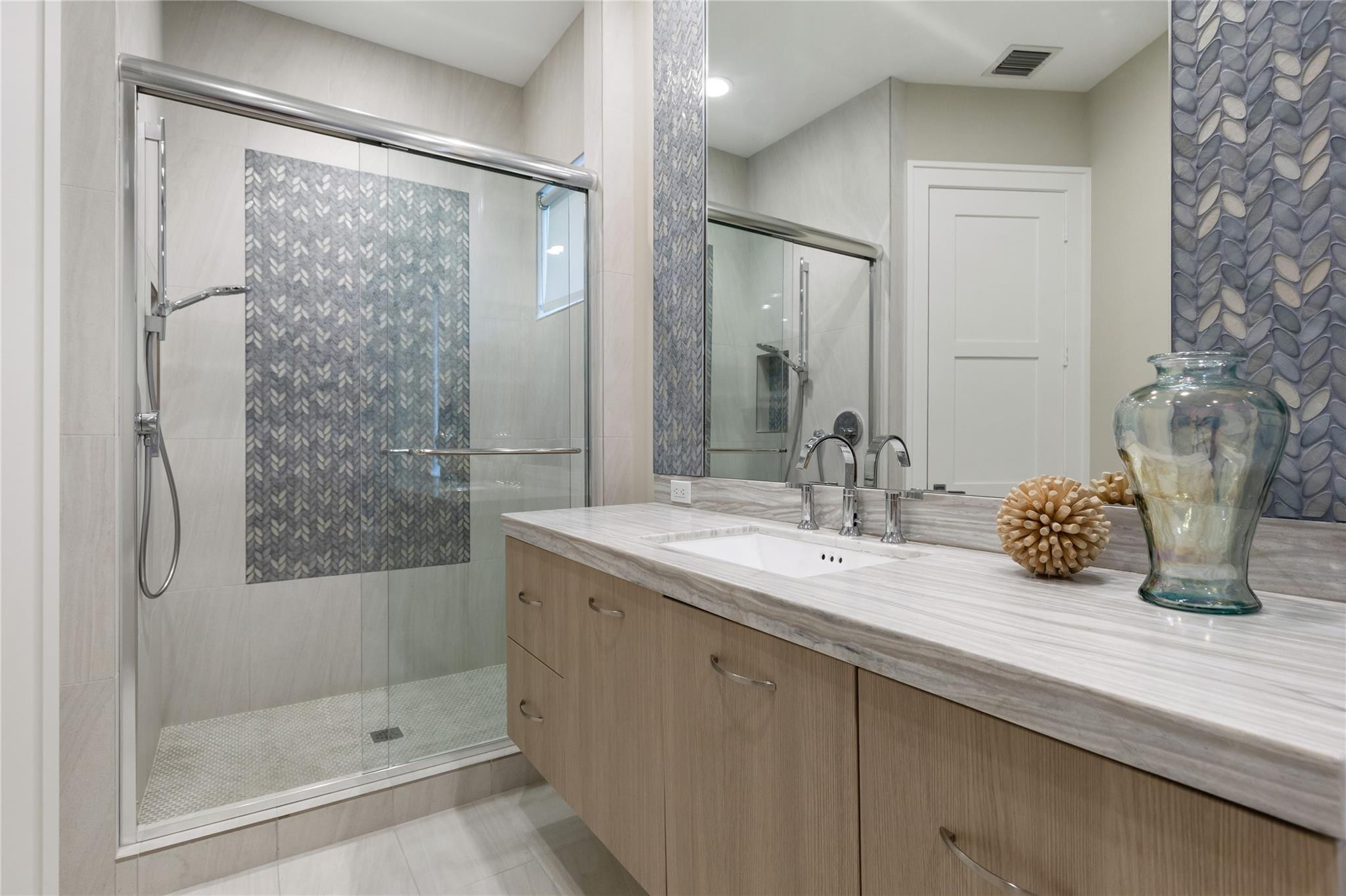 3211 Northeast 27th Avenue Lighthouse Point, FL 33064 - Photo 51 of 71 a bathroom with a granite countertop sink a mirror and shower
