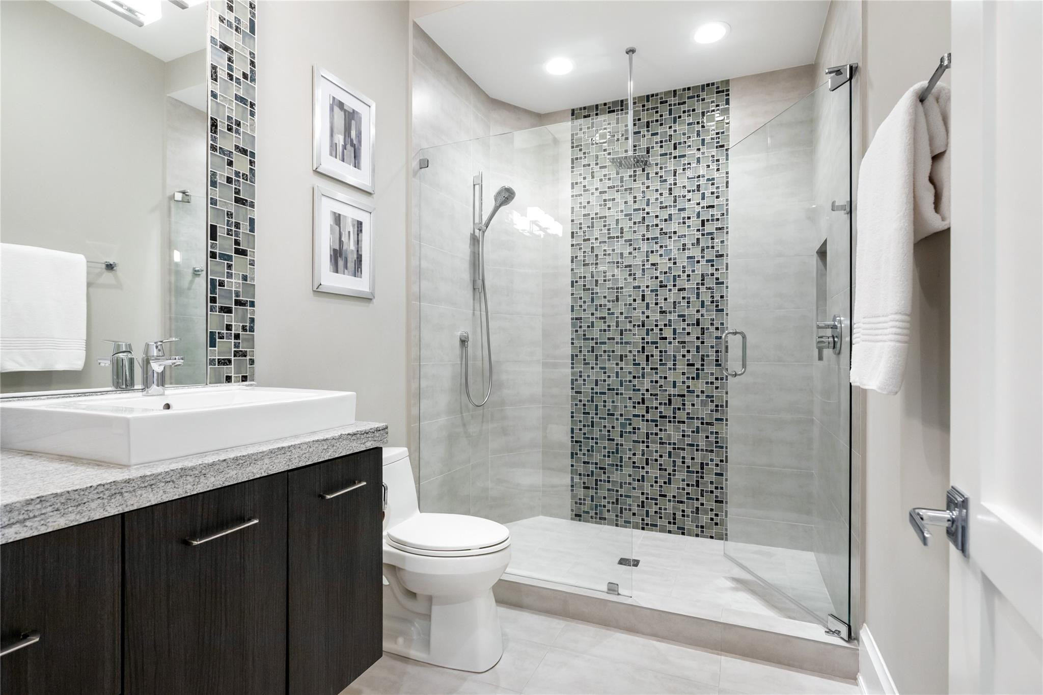 3211 Northeast 27th Avenue Lighthouse Point, FL 33064 - Photo 53 of 71 a bathroom with a sink a toilet and shower