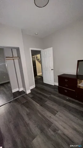 a view of a room with wooden floor