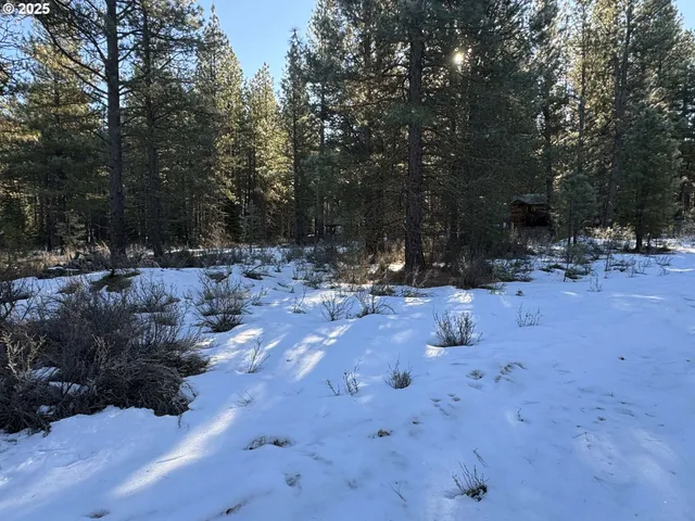 a backyard of a house with fire pit and outdoor seating