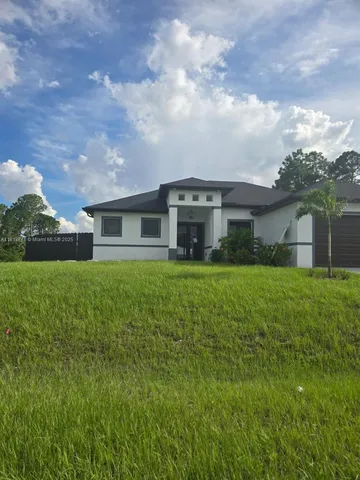 a front view of house with yard and green space