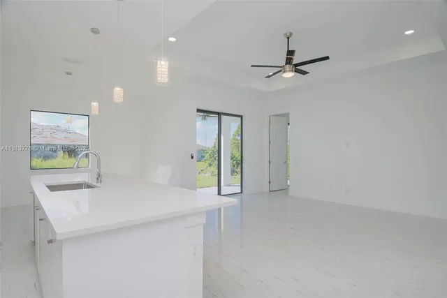 a view of an empty room with window and cabinet
