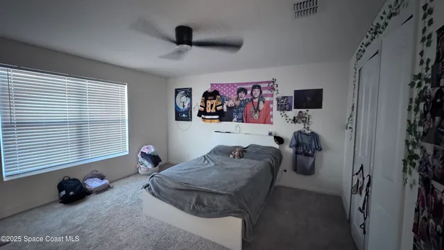 a bedroom with furniture and a window