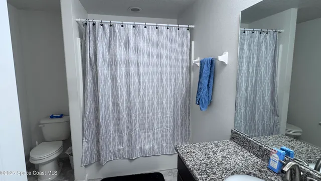 a bedroom with a rug and a toilet